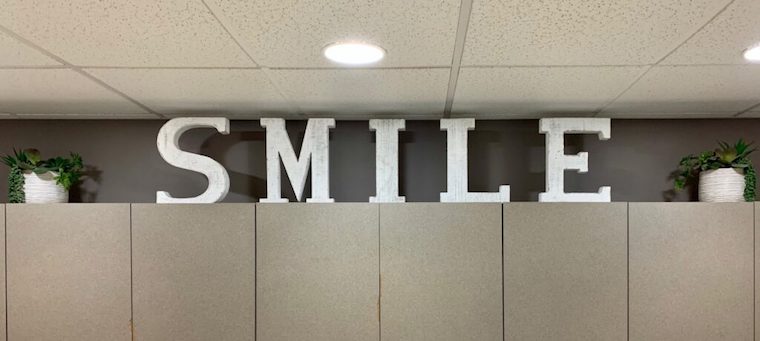 Smile art over cabinets in office
